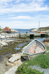 Boat near small fishing town with colourful houses near Peggys Cove, Halifax, Nova Scotia, Canada. Beautiful sunny day view.