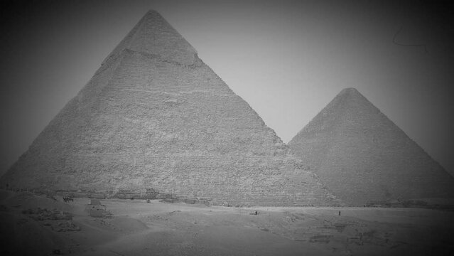 Giza pyramid complex, also called Giza Necropolis, is site on Giza Plateau near Cairo, Egypt. Pyramids of Khufu and Khafre. Video in retro style like an old black and white film