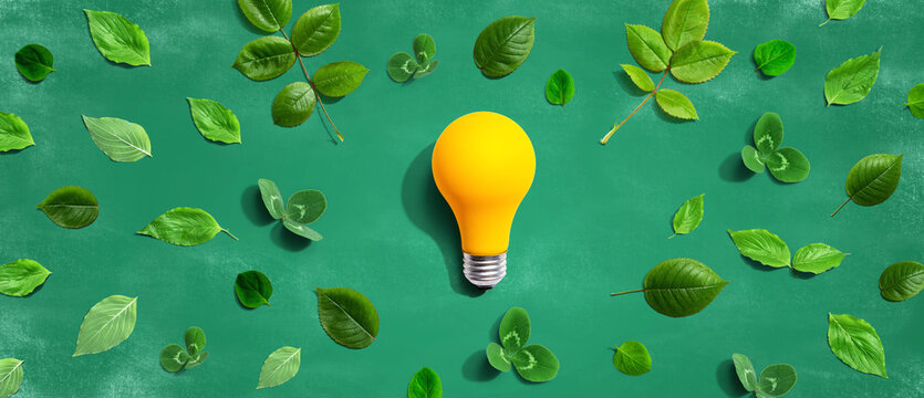 Yellow light bulb with green leaves