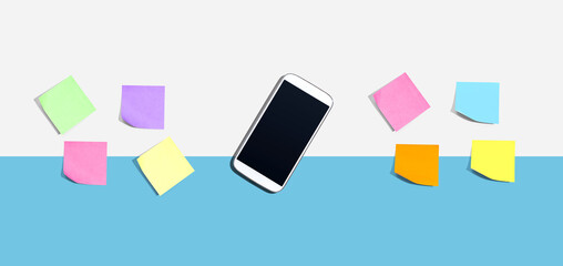 Smartphone with many colurful sticky notes from above