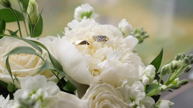Wedding rings on white roses