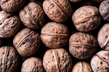 Ripe, whole walnuts in a wrapper close-up.