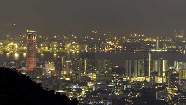 High angle view Komtar tower, Penang and surrounding in night. Timelapse foggy cloud motion