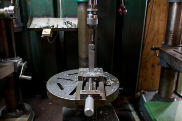 Part machining with drilling machine