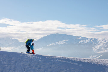 man and woman skiing and snowboarding in the mountains, ski resort