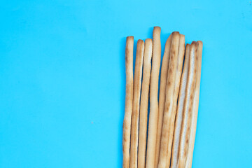 Bread sticks on blue background