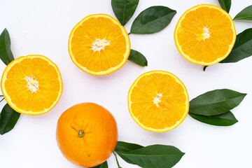 Fototapeta na wymiar Orange fruit with green leaves on white background.