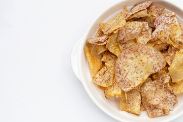 Crispy taro chips on white background.