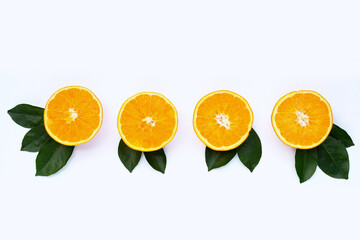 Orange fruit with green leaves on white background.