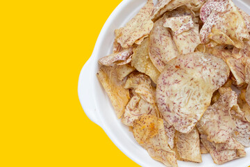 Crispy taro chips on white background.