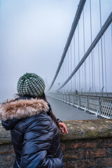 Woman looking at famous Clifton bridge in Bristol England	