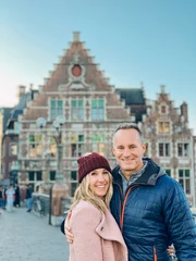 Papier Peint photo Brugges Couple standing on a busy street in Belgium