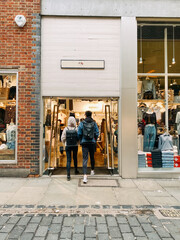 couple shopping in the city wearing backpacks