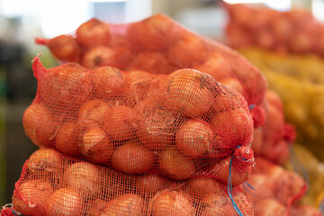 Kilograms of onions in a net at the market