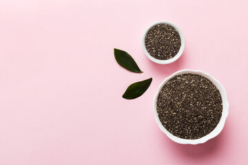 Chia seeds in bowl on colored background. Healthy Salvia hispanica in small bowl. Healthy superfood