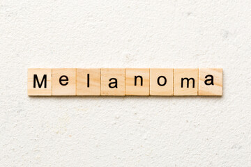 melanoma word written on wood block. melanoma text on table, concept