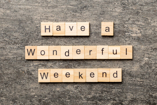 Have a wonderful weekend word written on wood block. Have a wonderful weekend text on cement table for your desing, Top view concept