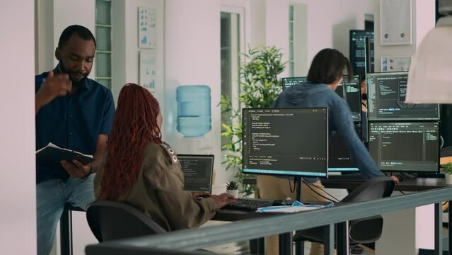 African american team of cloud programers talking about programming compiling code, working on new user interface development. Coders doing teamwork to develop server algorithms.