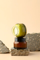Jars of natural moisturizer cream on stone podium. Organic skin care cosmetics, spa beauty products design, branding.