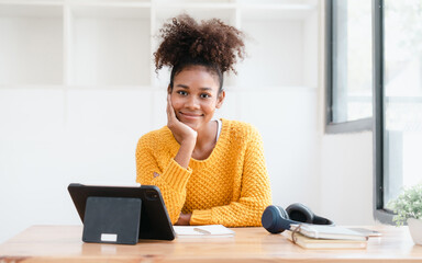 Pretty young african american student woman study online class in tablet video call zoom teacher learning english language experiment in knowledge-gathering from any location of their choice.