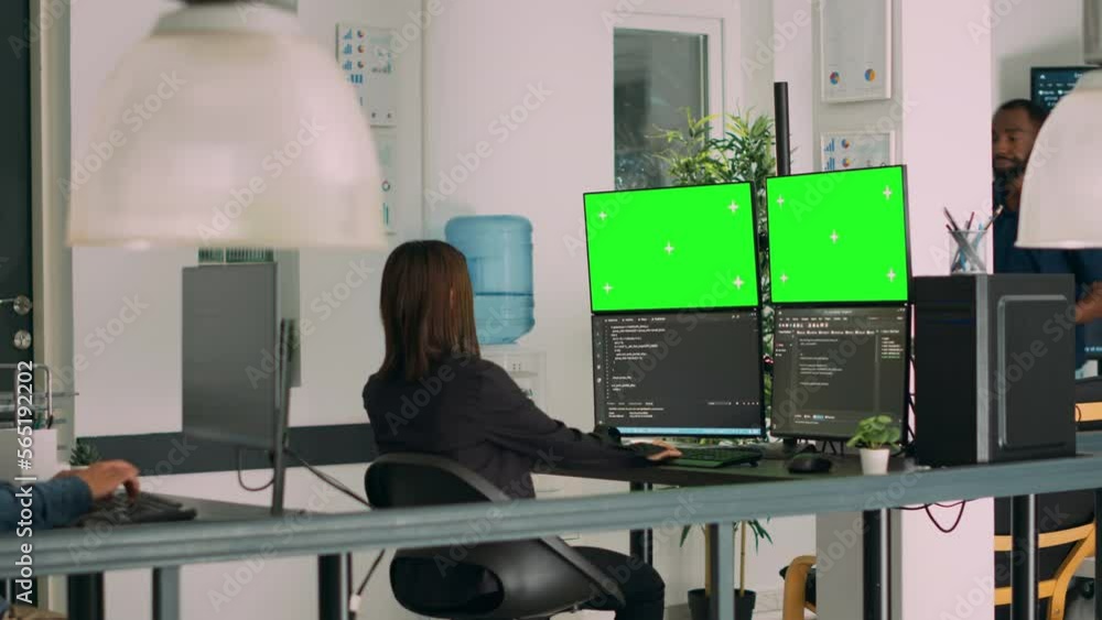 Poster asian system engineer using html script code and greenscreen on multiple monitors in software innova