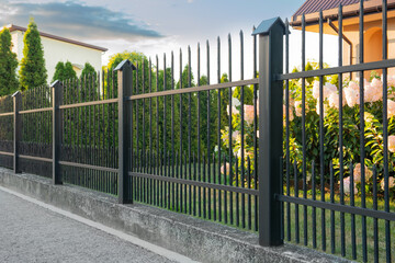 Beautiful black iron fence near pathway outdoors - Powered by Adobe