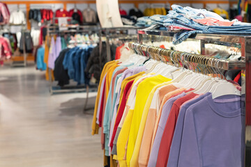 modern collection of children's cotton clothes in child clothes shop. selective focus