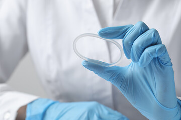 Doctor holding diaphragm vaginal contraceptive ring, closeup