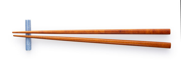 Wooden chopsticks and chopstick rests placed on a white background.