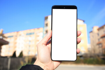 Man using weather forecast app on smartphone outdoors on sunny day, closeup
