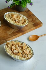 baked klapertaart topped with almond slice 