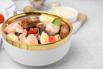 Delicious salad with croutons, tomatoes and shrimp served on white table, closeup. Space for text