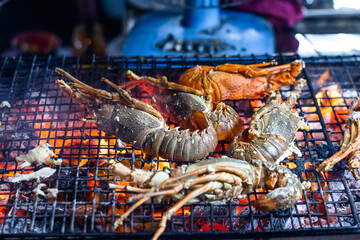 The lobsters are flame grilled to cook.