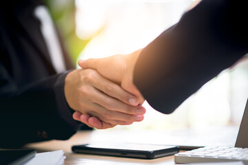Obraz premium Businessmen shaking hands to indicate a business deal,successful contract management of the company,signing an agreement,business partner,New opportunities for the future of the industry,joint venture