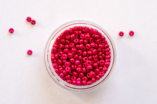 Dark Pink Beads in a Container