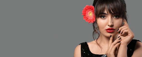 Stylish young woman on grey background with space for text