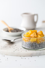 Close up of a chia pudding topped with chopped mango, ready for eating.