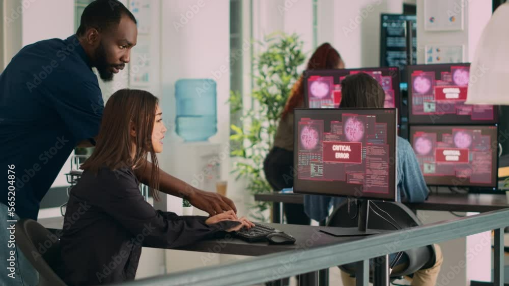 Poster diverse group of engineers having computer hacked and system crash on multiple monitors, reading cri
