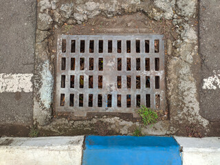 Water Drain on pavement road. Steel closed drains.