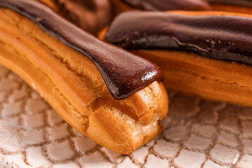 Plate of sweet chocolate eclairs, closeup