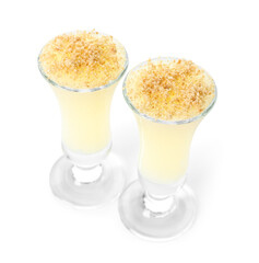 Shots of delicious pudding with vanilla sticks isolated on white background