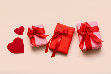Beautiful gifts and paper hearts on white background. Valentine's Day celebration