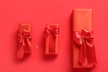 Beautiful gift boxes for Valentine's Day celebration on red background
