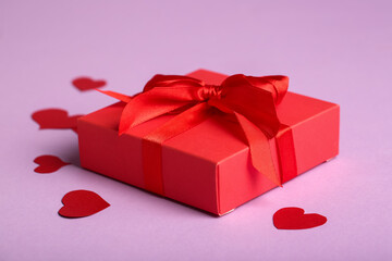 Beautiful gift and paper hearts on pink background. Valentine's Day celebration