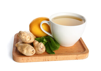 Cutting board with ginger roots, lemon, mint and cup of tea isolated on white background
