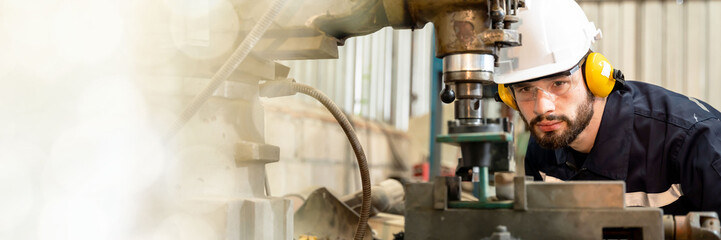 Banner Team man of engineers practicing maintenance Taking care and practicing maintenance of old machines in the factory so that they can be used continuously.