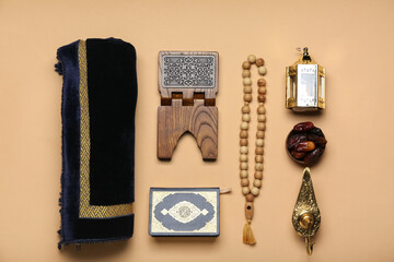 Aladdin lamp, dates, Muslim lantern, tasbih, Koran and mat for Ramadan on beige background