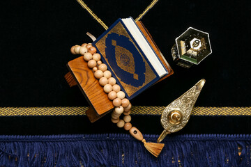 Aladdin lamp, Muslim lantern, Koran and prayer beads for Ramadan on mat