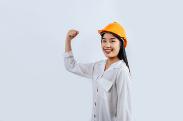 Young female engineer wearing Yellow helmet and healthy sign posture
