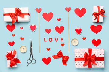 Composition with gift boxes, hearts and word LOVE on blue background. Valentine's Day celebration